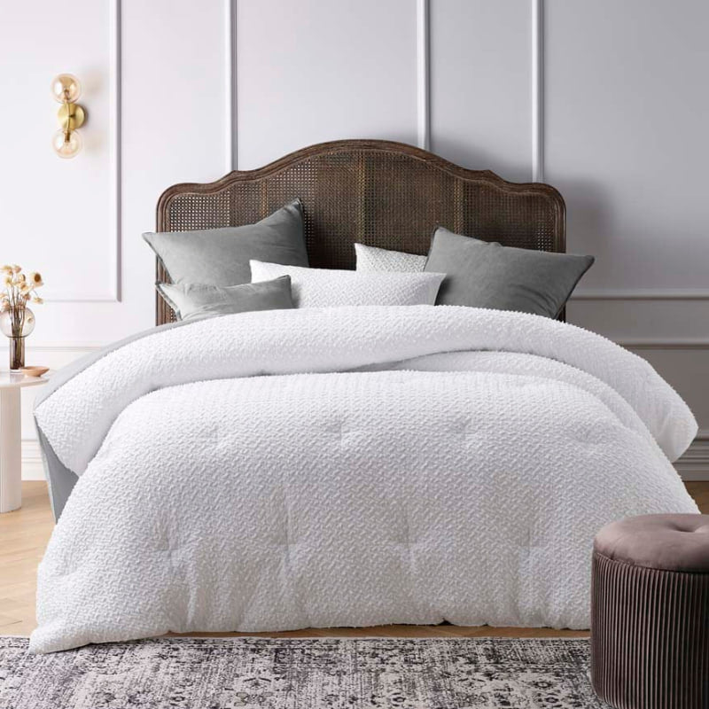 Textured jacquard comforter set in classic white with clipped dot detail, and polyester filled with quilting for warmth.