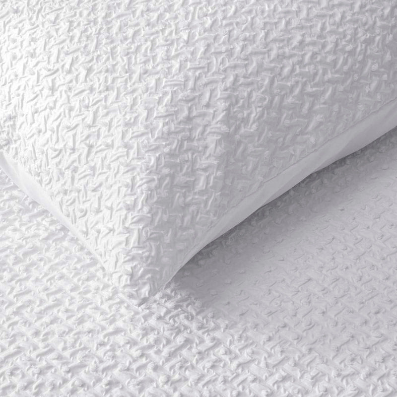 Close up shot of a unique texture of jacquard quilt cover set with clipped dot detail, a beautiful update to white bedding.