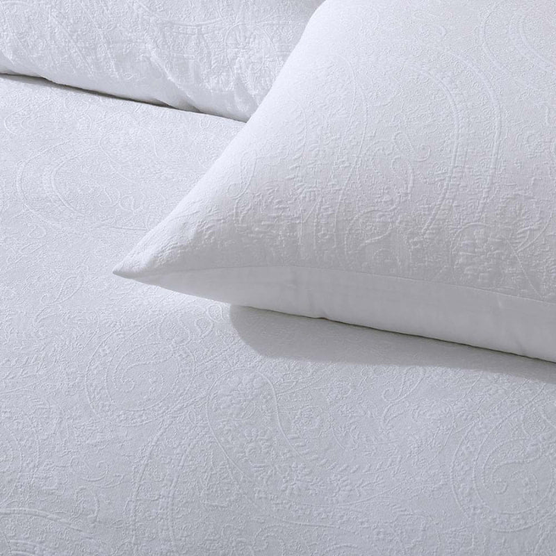 alt="Zoom in details of a white quilt cover set featuring a stunning timeless jacquard design."