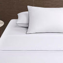 alt="Deluxe cotton white and black sheet set in a luxurious bedroom"