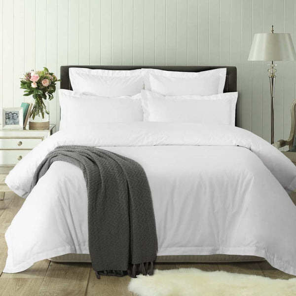 alt="White deluxe cotton quilt cover set in a luxurious bedroom"