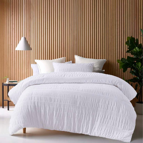 alt="A white quilt cover set gives the classic look of crisp white bed linen while the texture ensures your bedroom looks anything but basic."
