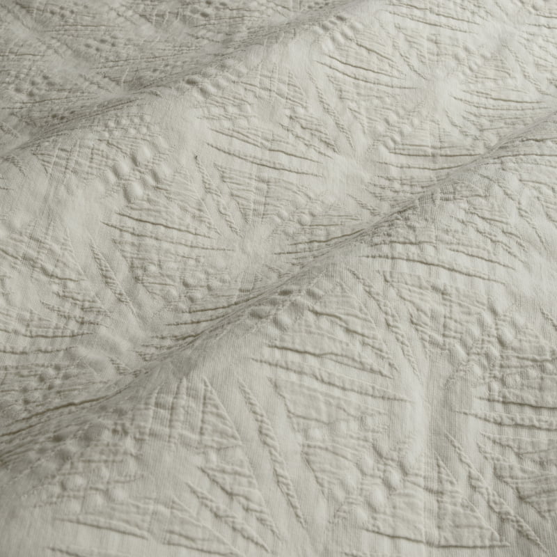 Close-up details of a natural quilt cover set featuring a subtle geometric embossed pattern.