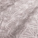 Close-up details of a cosy mauve quilt cover set featuring a subtle geometric embossed pattern.