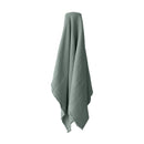 alt="A green throw featuring a 4 layer gauze cotton fabric with natural frayed edge"