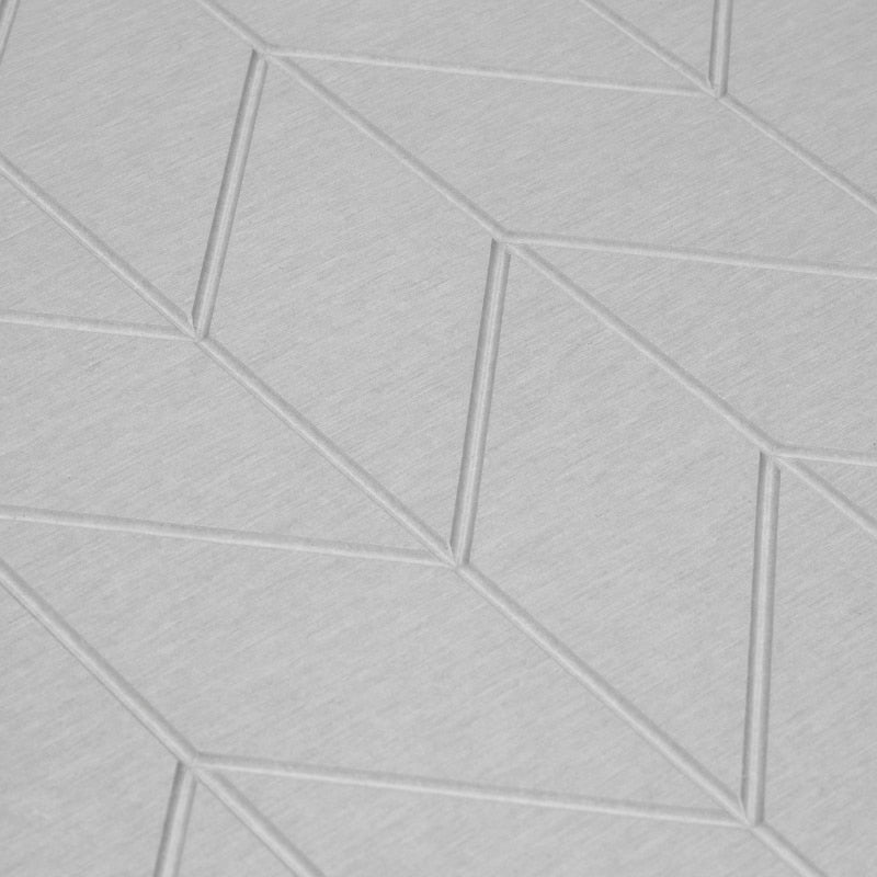 Close up details of a light grey bath stone with its super porous surface, keeps your floor clean and dry, minimizing bacteria growth.