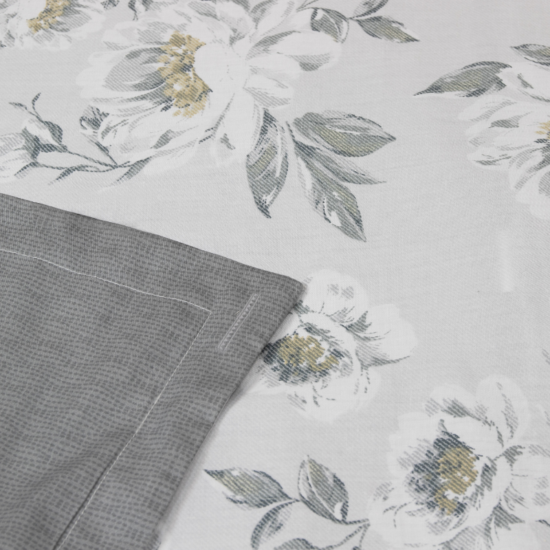 A close-up look of a serene cover set featuring a floral-patterned bed, enhancing the tranquil atmosphere.