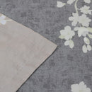 Detailed view of a grey and white floral design on a bed sheet, showcasing the elegant Amesbury Natural quilt cover set.