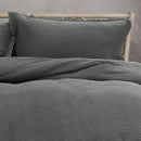 Experience an stylish grey bed with crinkled textures and vintage frayed edges, perfect for winter bedding.