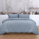 Cosy blue quilt cover with a geometric design, adding a modern touch to a serene bedroom retreat.