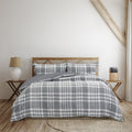 Cosy bed featuring a grey quilt cover, adding timeless charm and warmth to your bedroom decor.
