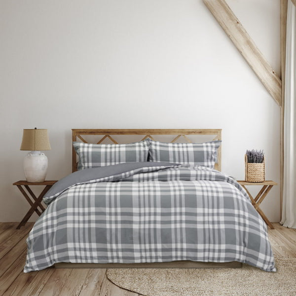 Cosy bed featuring a grey quilt cover, adding timeless charm and warmth to your bedroom decor.
