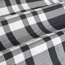 A stylish bed featuring a navy quilt cover set, enhancing the room's charm and comfort for relaxation.