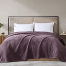 Overhead view of mauve blanket in use, highlighting its generous size and fleece finish