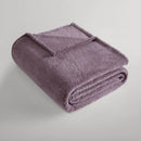 Mauve blanket folded neatly, showing its plush teddy texture.