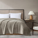 Ardor Boudoir Teddy Natural Blanket draped across a bed with soft rippling texture