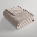 Natural blanket folded neatly, showing its plush teddy texture.