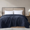 Overhead view of navy blanket in use, highlighting its generous size and fleece finish