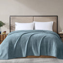 Overhead view of sea mist blanket in use, highlighting its generous size and fleece finish