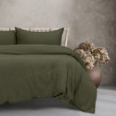 Luxurious beautifully made bed, complemented by a vintage-washed khaki quilt cover for ultimate relaxation.