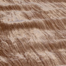 Detailed view of a luxurious quilt cover set exuding opulence and elegance in soft champagne tones.