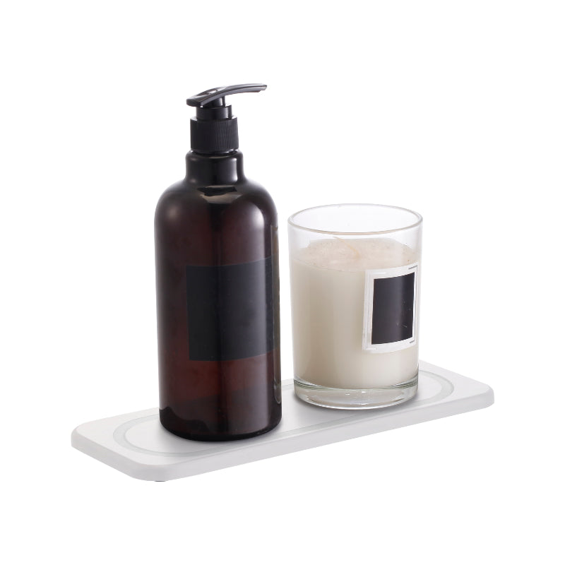 A sleek soap bottle, highlighting a stone white sink mat for a stylish touch.
