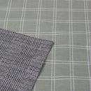 Closer look of a cosy grey quilt cover set in a bedroom adding a touch of timeless elegance to the sleeping space.