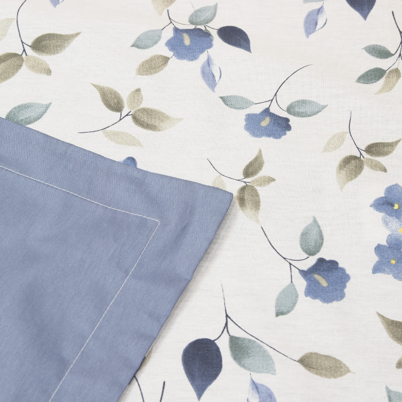 Close-up look of a blue and white floral cover set. Exuding elegance and tranquility in a serene bedroom setting.