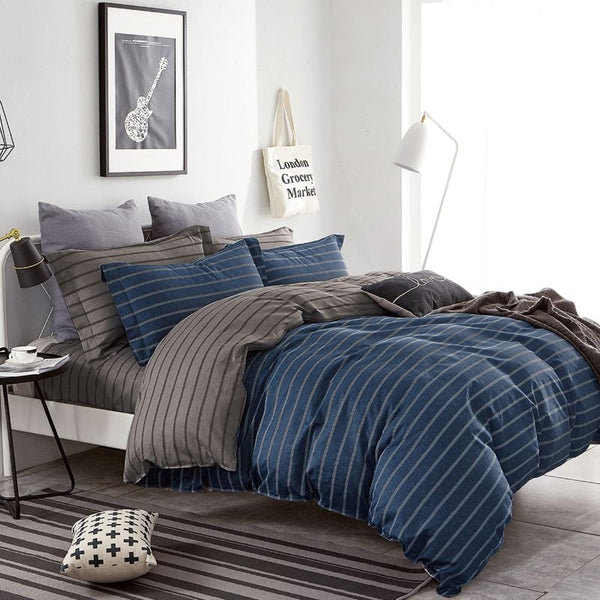 A deep navy quilt cover set with a grey striped design adds depth and sophistication to your space.