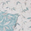 Close-up of elegant blue and white floral fabric featuring a botanical print, ideal for adding a serene touch to any bedroom setting.