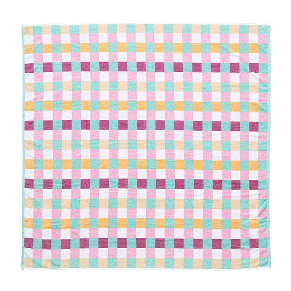 A vibrant sorbet checkered blanket on a white background, perfect for beach lounging or poolside picnics, showcasing its stylish check pattern.