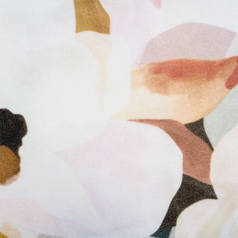 Close-up of a stunning multicoloured floral painting on plush cotton velvet, showcasing nature's beauty indoors.