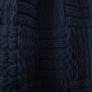 Close-up of a navy woven texture and yarn detail on the Asha Throw