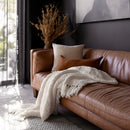 Bambury Asha White Throw draped over the sofa in a softly lit living space