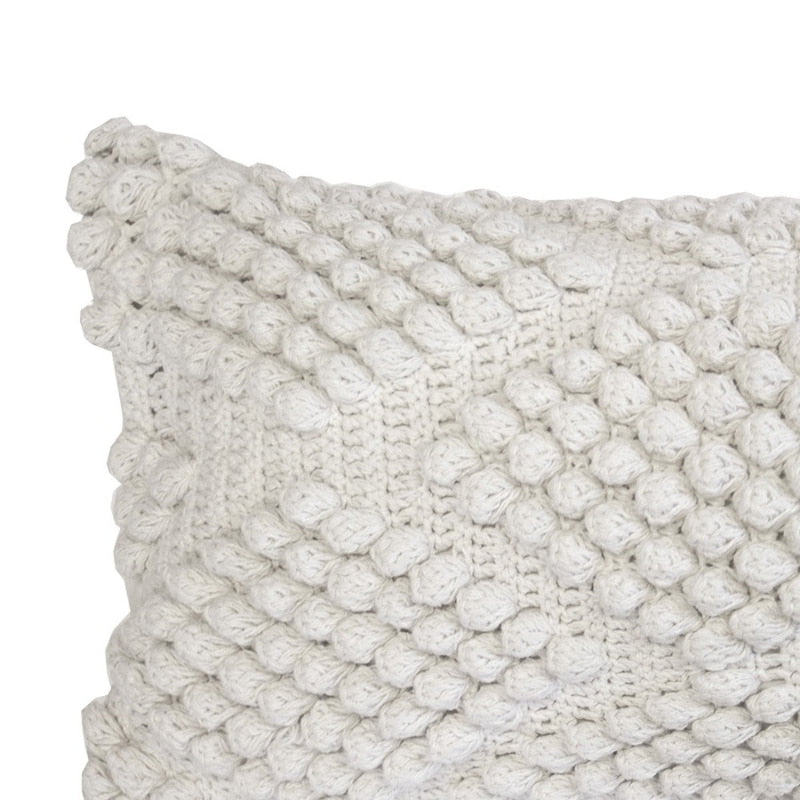 alt="Close-up view of an ivory cotton yarn woven diamond pattern rectangular cushion"
