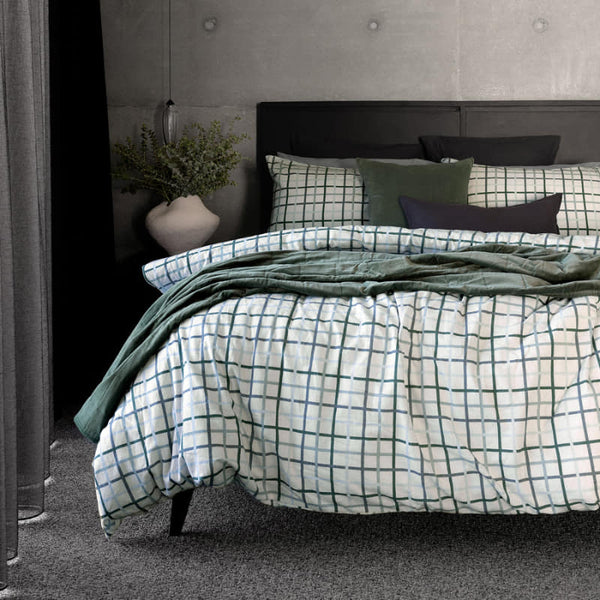 A classic blue and green check design flannelette quilt cover set styled on a bed
