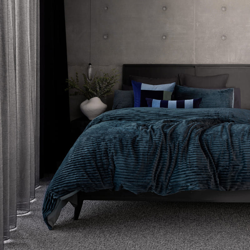 Bambury Channel Petrol Quilt Cover Set styled on a bed in a modern bedroom