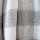 Detail view of a stone check pattern of the Cosmo Throw captured in soft natural light
