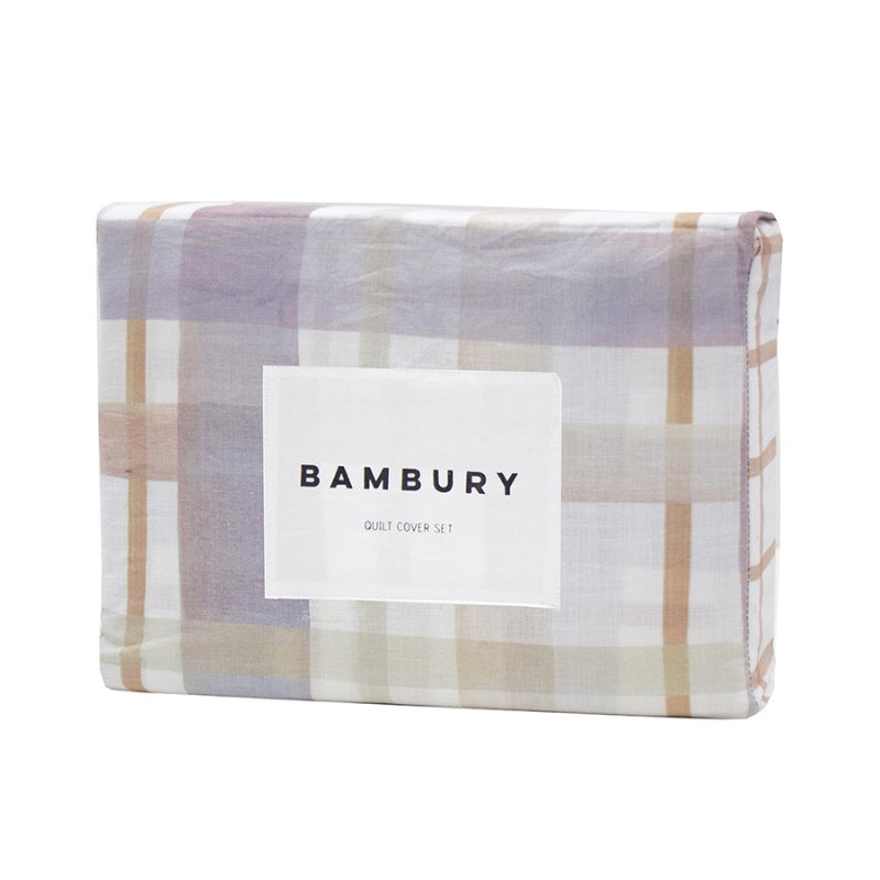 alt="A digitally printed hand-painted watercolour check pattern in sage green, lilac ash, and tan on a crisp white base quilt cover set in a packaging"
