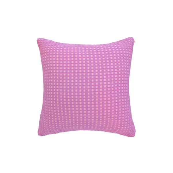 A pink cushion featuring, crafted from two-toned waffle fabric, enhancing any living space with elegance.