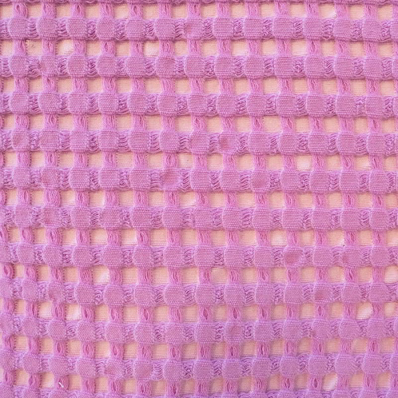 Detailed view of a pink cushion, highlighting the sophisticated texture ideal for stylish home interiors.