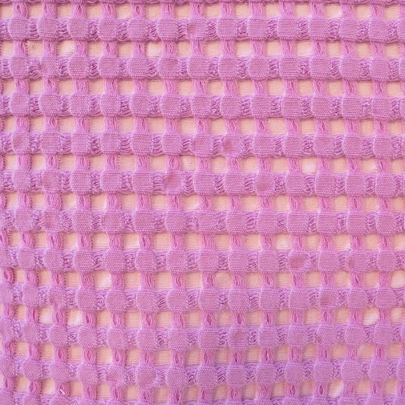 Close-up of luxurious Dora Orchid Throw, showcasing texture and versatility for stylish home decor.