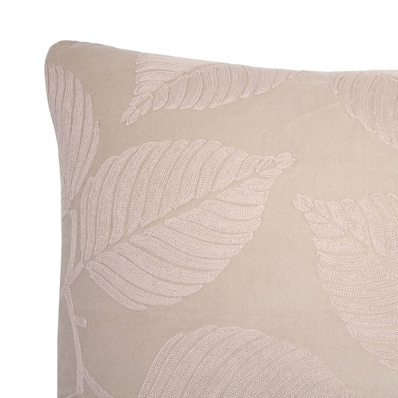 alt="Close-up view of a natural velvet cushion designed with eucalyptus leaves"