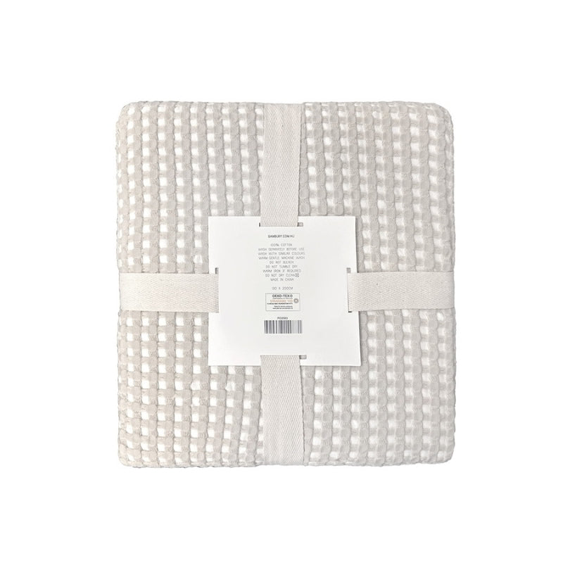 alt="Back view of a two-toned natural throw with a beautiful waffle texture"