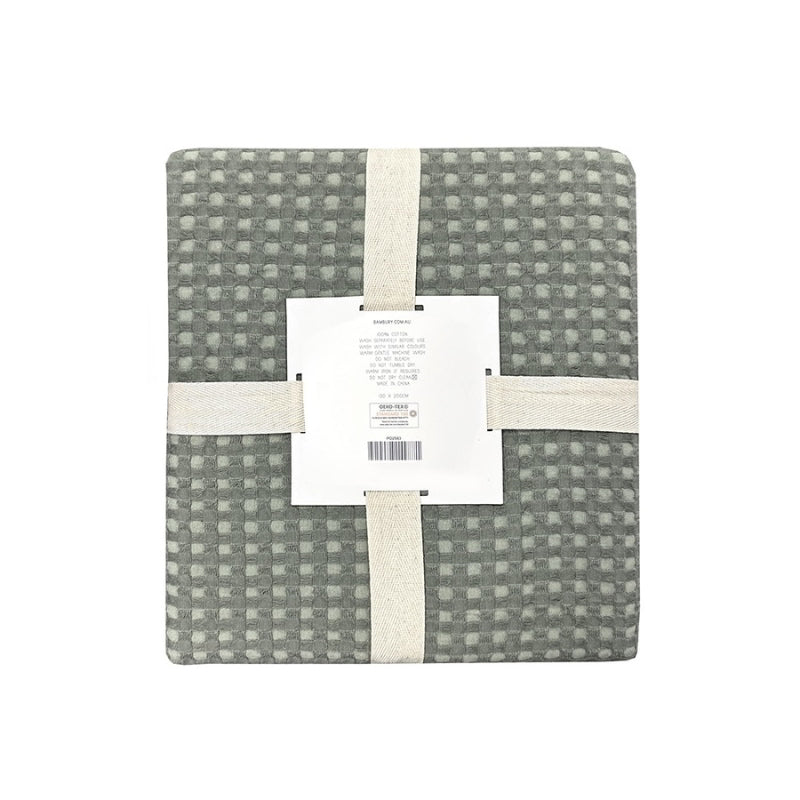 alt="Back view of a two-toned sage green throw with a beautiful waffle texture"