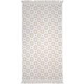 alt="Natural beach towel designed with floral pattern and tassels on both ends"