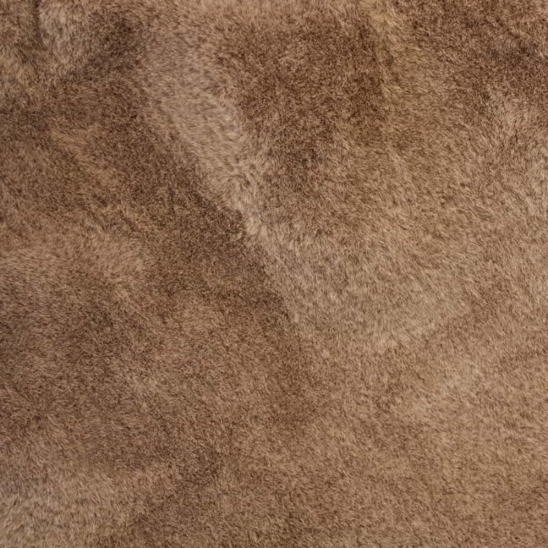 Detailed shot of a square brown cushion made of soft faux fur fabric, perfect for adding extra comfort and warmth to your couch or bed. Machine washable.