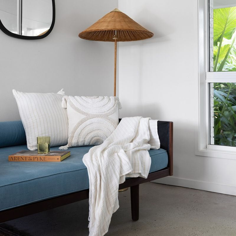 alt="Striped white and natural cushion in a modern-theme living space"