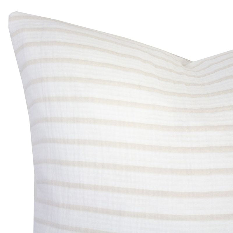 alt="Close-up view of a striped white and natural cushion"