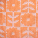 Detailed view of the vibrant hooded towel featuring orange flowers, perfect for keeping kids warm and dry after swimming activities.